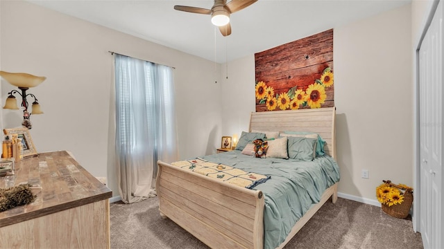 bedroom featuring ceiling fan, a closet, and dark colored carpet