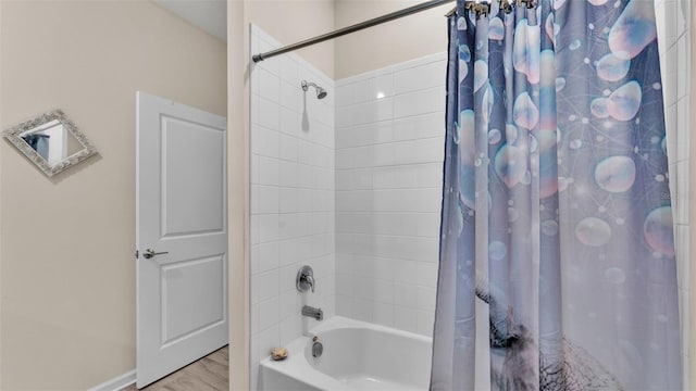 bathroom with hardwood / wood-style flooring and shower / bathtub combination with curtain