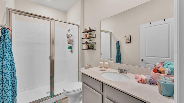 bathroom with vanity, toilet, and walk in shower