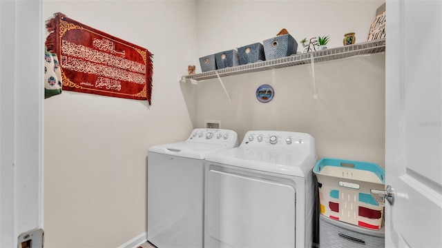 laundry room featuring washing machine and clothes dryer