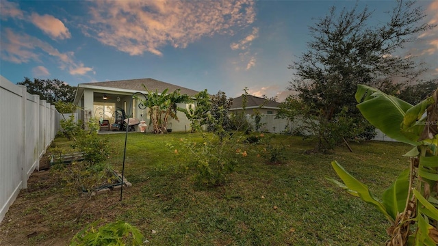 exterior space featuring a lawn and ceiling fan