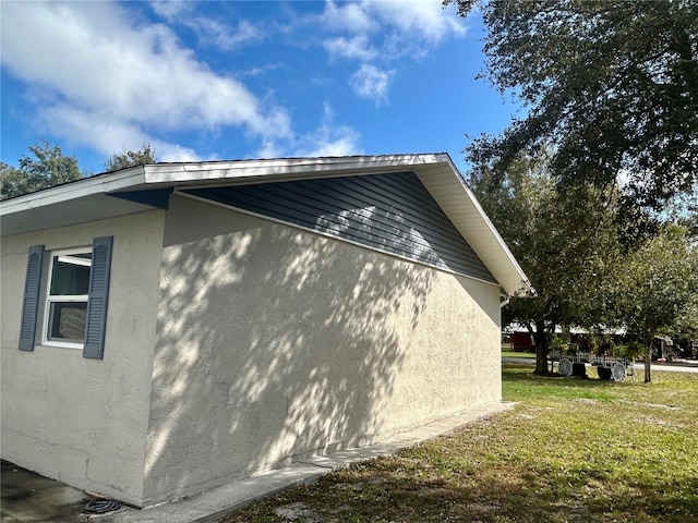 view of side of home featuring a yard