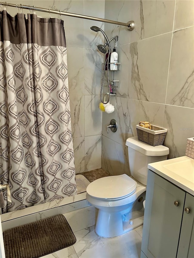 bathroom with curtained shower, vanity, tile walls, and toilet