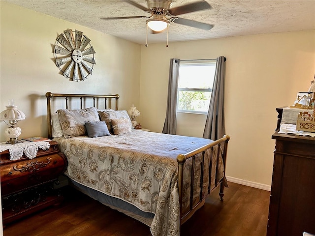 bedroom with a textured ceiling, dark hardwood / wood-style flooring, and ceiling fan