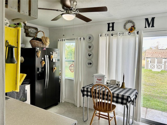 kitchen featuring stainless steel fridge with ice dispenser, ceiling fan, and ornamental molding