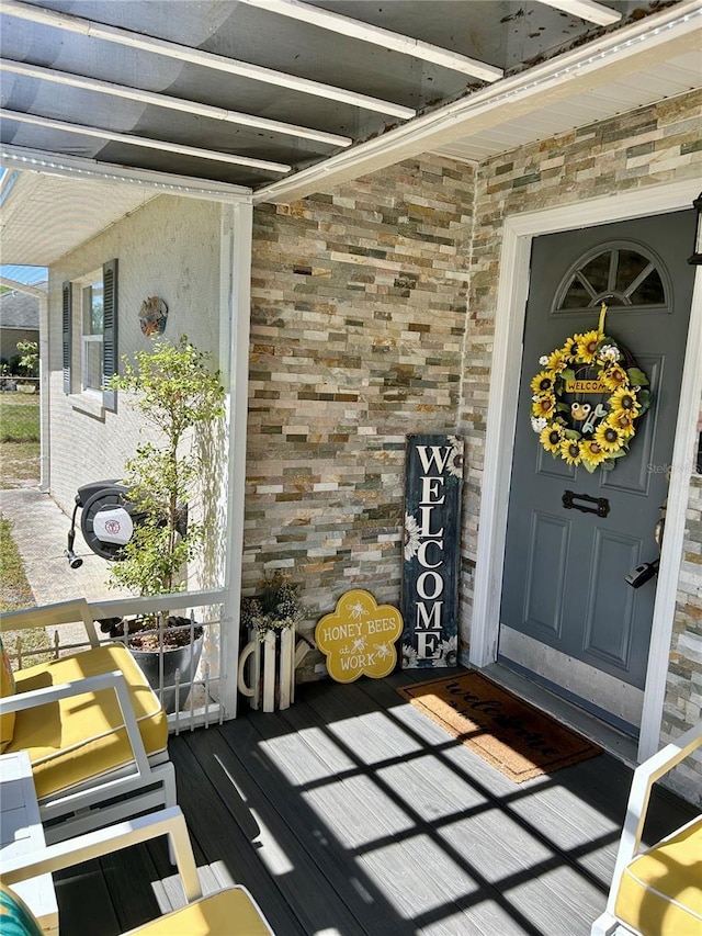 entrance to property with stone siding and brick siding