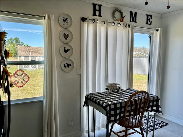 dining area with crown molding and baseboards