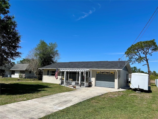 single story home with stucco siding, an attached garage, a front lawn, and concrete driveway