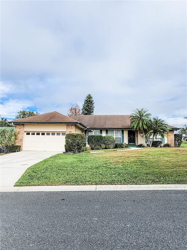 ranch-style house with a front yard and a garage