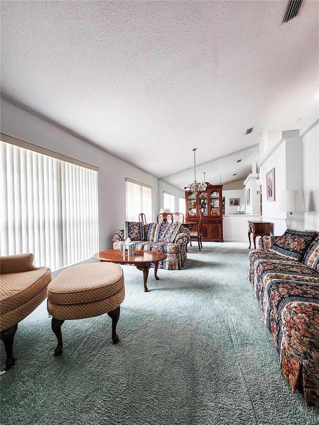 living room featuring lofted ceiling, carpet, and a textured ceiling