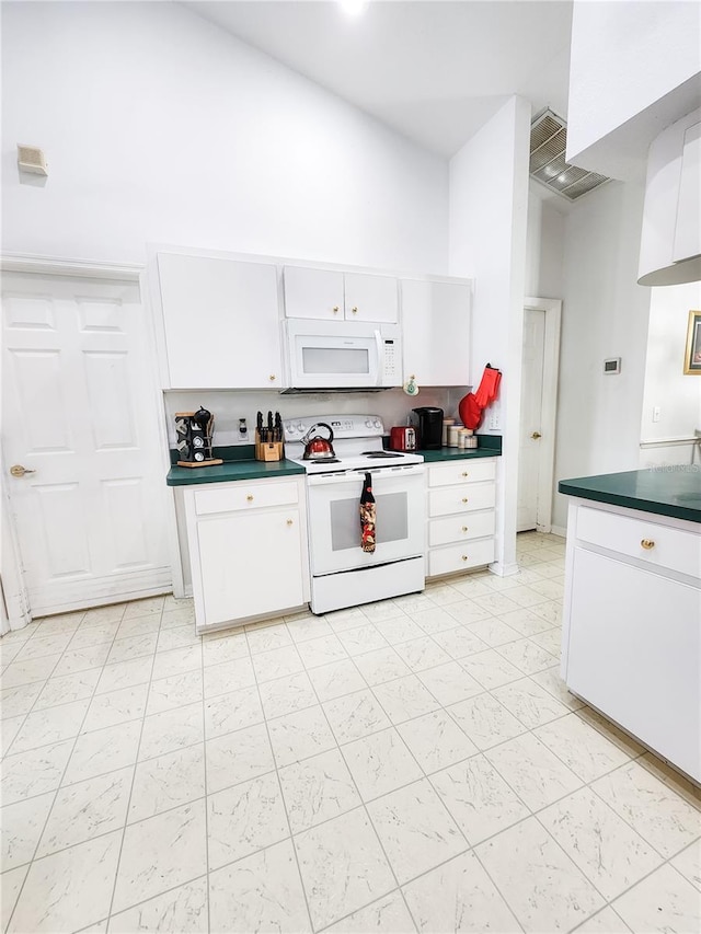 5805 Danterbury Ct, Lakeland, FL 33810 - kitchen with white cabinets, a towering ceiling, and white appliances