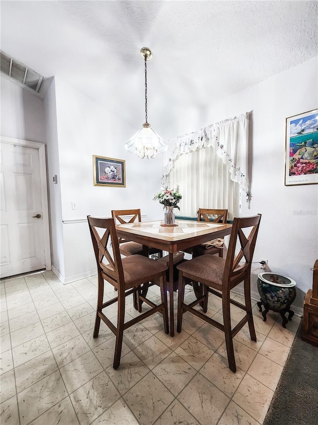 5805 Danterbury Ct, Lakeland, FL 33810 - dining room featuring a textured ceiling and an inviting chandelier