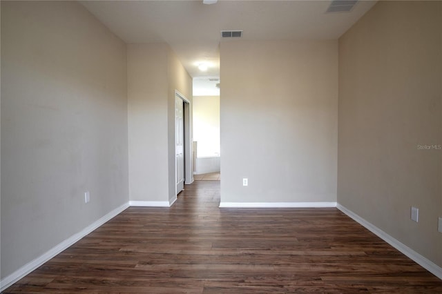 spare room featuring dark hardwood / wood-style floors