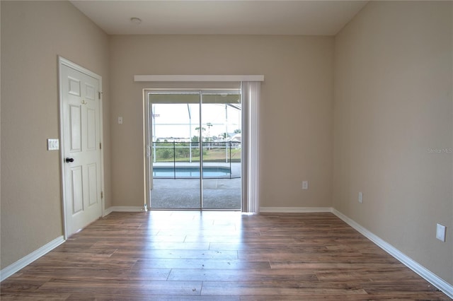 unfurnished room featuring dark hardwood / wood-style flooring