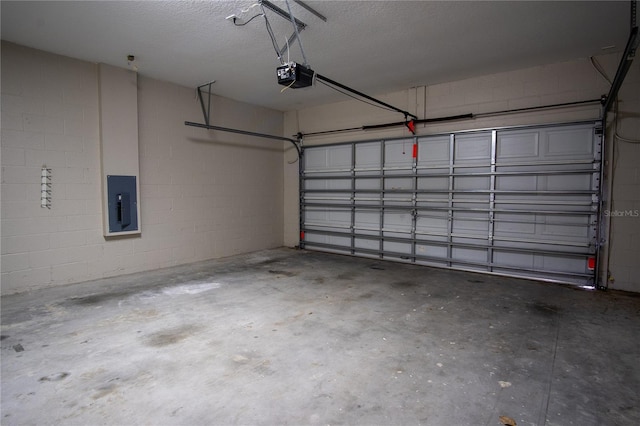 garage featuring electric panel and a garage door opener