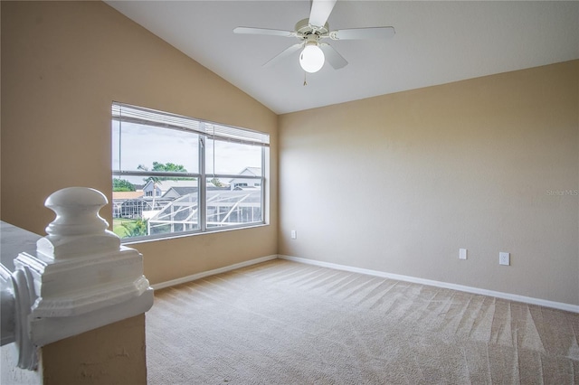 unfurnished room with ceiling fan, lofted ceiling, and light carpet