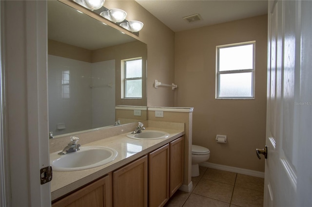 bathroom featuring tile patterned flooring, vanity, and toilet