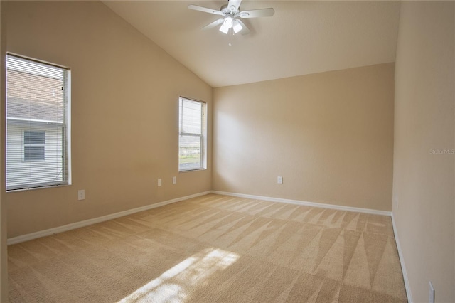 carpeted spare room with ceiling fan and lofted ceiling