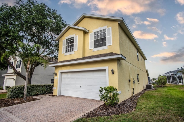 property exterior at dusk with central AC, a yard, and a garage