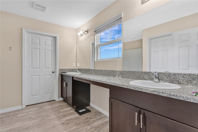 bathroom featuring hardwood / wood-style floors and vanity