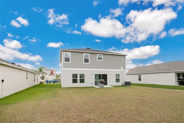 rear view of house featuring central AC unit, a patio area, and a yard