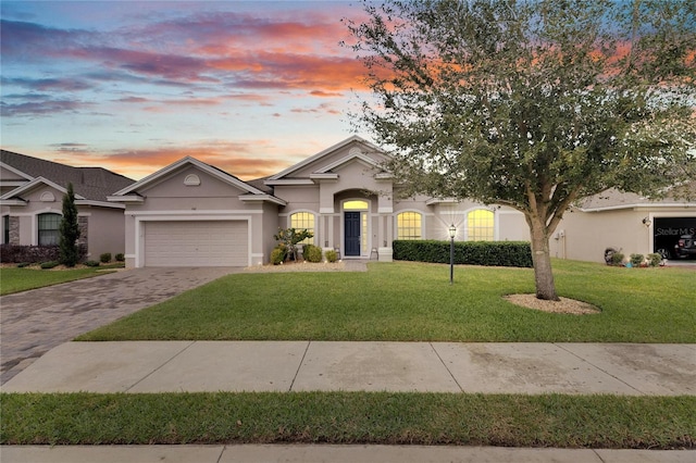 ranch-style house with a lawn and a garage