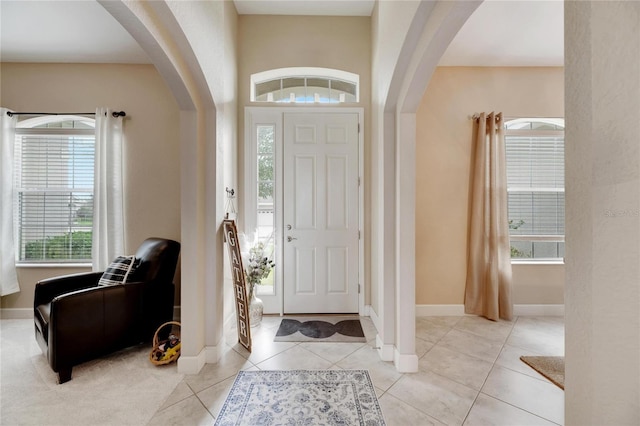 332 Lake Mariana Way, Auburndale, FL 33823 - entryway with arched walkways, healthy amount of natural light, and light tile patterned floors
