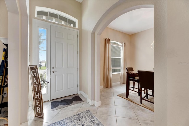332 Lake Mariana Way, Auburndale, FL 33823 - entrance foyer with arched walkways, healthy amount of natural light, and light tile patterned floors