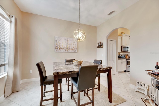 332 Lake Mariana Way, Auburndale, FL 33823 - dining space with light tile patterned flooring, arched walkways, plenty of natural light, and a chandelier