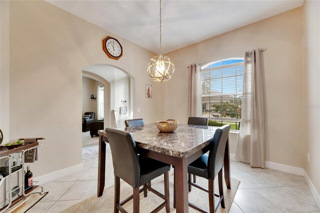 332 Lake Mariana Way, Auburndale, FL 33823 - dining space featuring arched walkways, light tile patterned flooring, and a chandelier