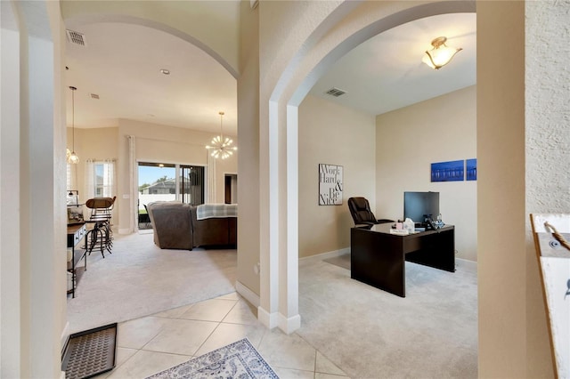 office area with light carpet and a chandelier