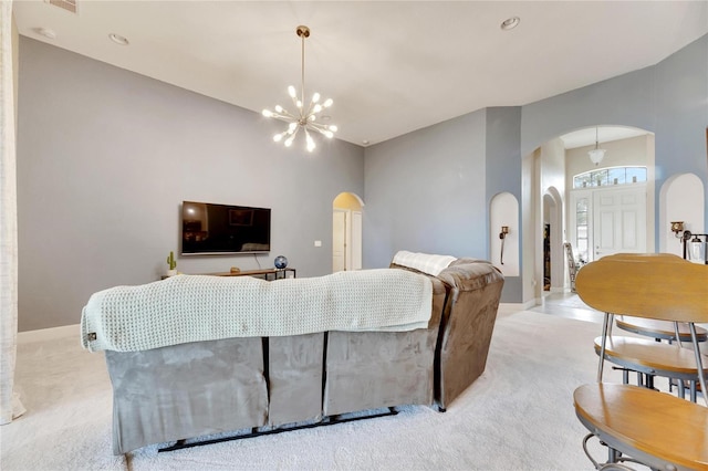 332 Lake Mariana Way, Auburndale, FL 33823 - living room with arched walkways, light colored carpet, and a chandelier