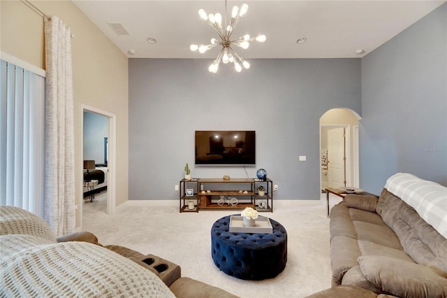 carpeted living room with a chandelier