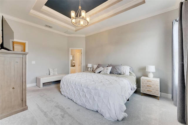 bedroom featuring connected bathroom, a tray ceiling, crown molding, a chandelier, and carpet floors