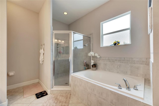 bathroom with separate shower and tub and tile patterned flooring