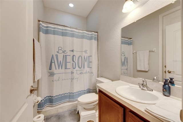 bathroom with vanity, curtained shower, and toilet