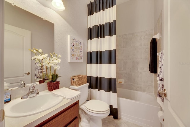 full bathroom featuring tile patterned flooring, shower / bath combo with shower curtain, vanity, and toilet