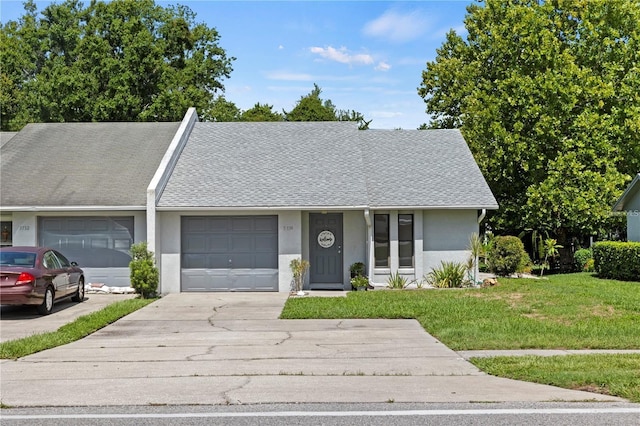 single story home with a garage and a front yard