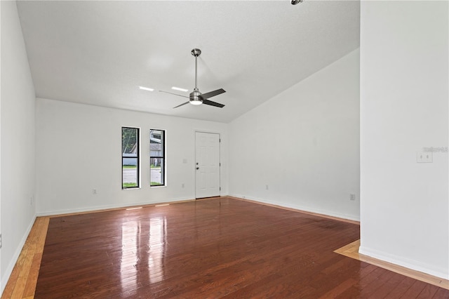 empty room with ceiling fan, wood-type flooring, and lofted ceiling