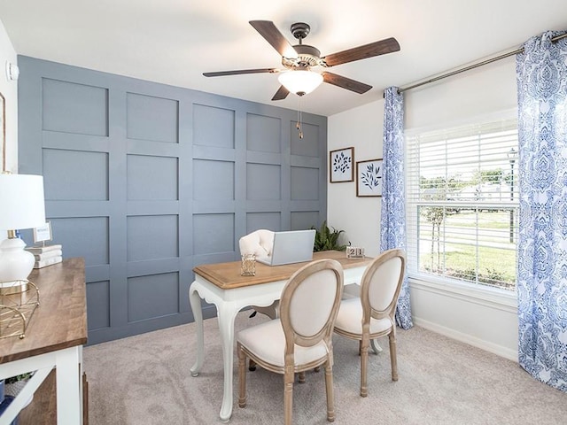 dining area with ceiling fan and light carpet