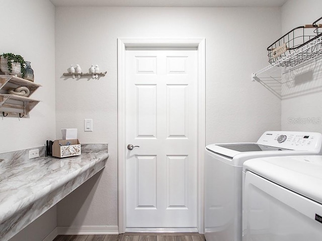 laundry room with light hardwood / wood-style floors and independent washer and dryer