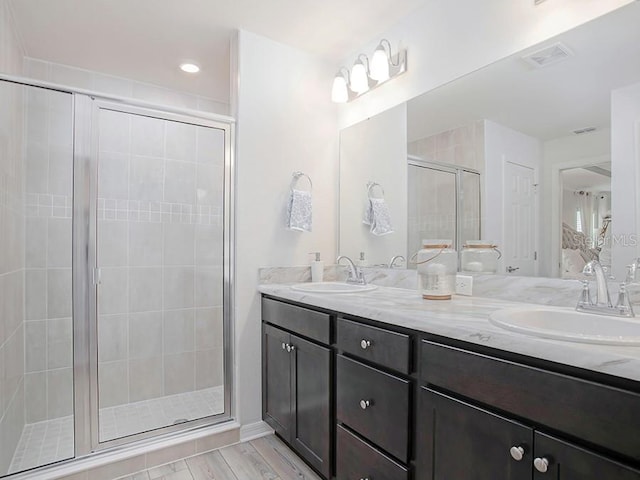 bathroom featuring vanity and a shower with shower door