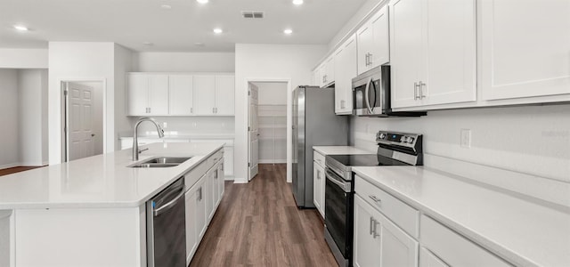 565 SW 77th Cir, Ocala, FL 34474 - kitchen with stainless steel appliances, a sink, dark wood finished floors, recessed lighting, and light countertops