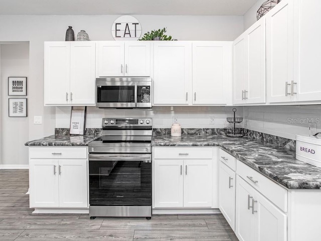 kitchen featuring white cabinets, appliances with stainless steel finishes, and light hardwood / wood-style flooring