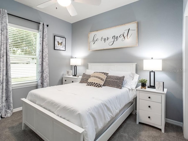 carpeted bedroom with multiple windows and ceiling fan