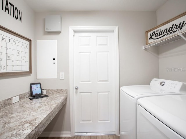 clothes washing area with washing machine and clothes dryer