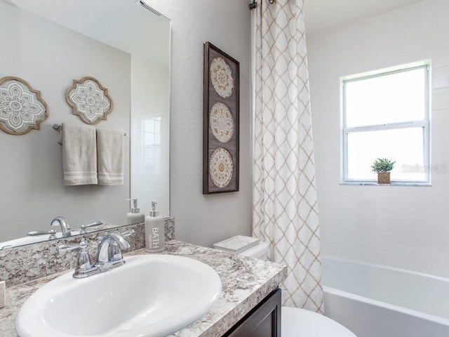 full bathroom featuring vanity, toilet, and shower / bathtub combination with curtain