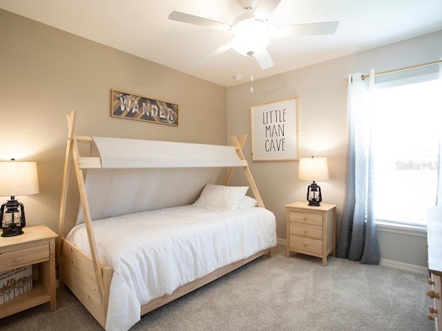 bedroom with ceiling fan and light carpet