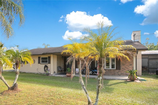 view of front of house with a front lawn and a patio