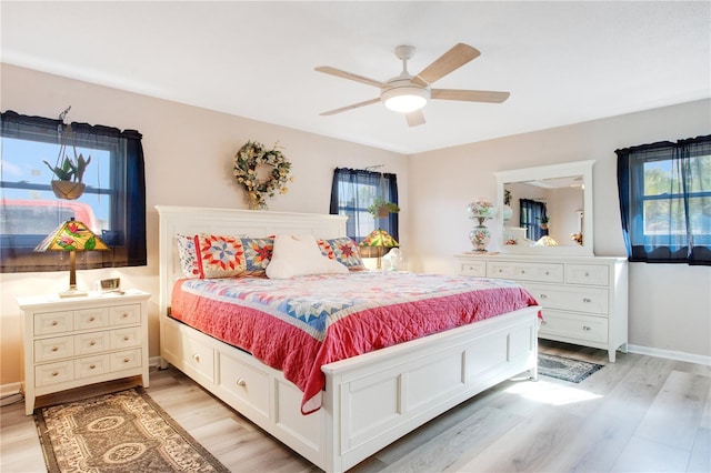 bedroom with ceiling fan and light hardwood / wood-style floors